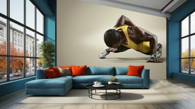 Sport. Young athletic man doing push-ups. Muscular and strong guy exercising. Isolated
 Wall mural