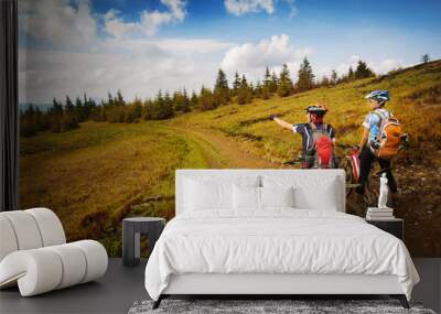 Two young bikers looking at the mountains Wall mural