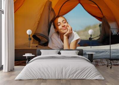 Dreamy lazy woman feeling good and enjoys free camping life during summer vacation. Wall mural