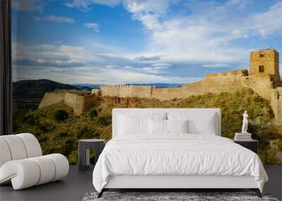 View on the castle Sagunto during sunny day and cloudy sunset Wall mural