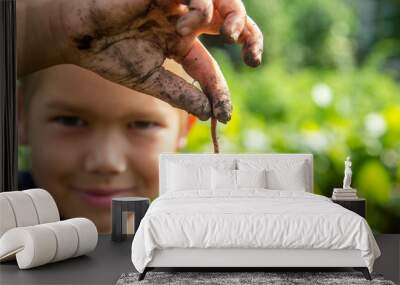 boy holds a red worm Wall mural