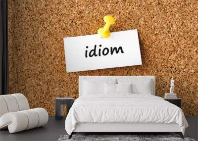 Idiom. Word written on a piece of paper, cork board background. Wall mural