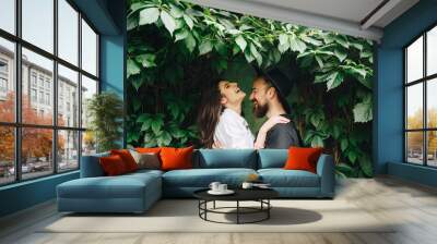 Beautiful young couple have fun. Her happiness is everything to him. Wall mural