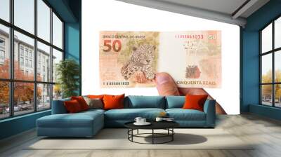 Brazillian Money, man holding 50 Reais notes isolated on white Wall mural