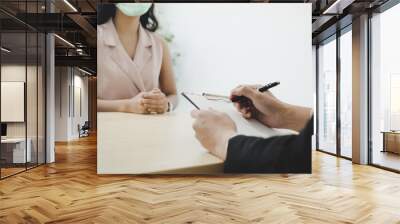 businessman manager and woman wearing protection face during job interview and explaining about his profile in meeting room at office, human resources, business job interview, new normal concept Wall mural