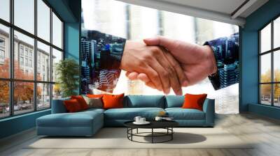 Deal. double exposure image of young businessman investor shaking hands with partner during new project contract with city background,  investment, business negotiating, partnership, teamwork concept Wall mural