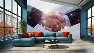 double exposure of business man handshake on modern office building background with network connection graphic diagram, partnership business,  teamwork global, technology and digital internet concept Wall mural