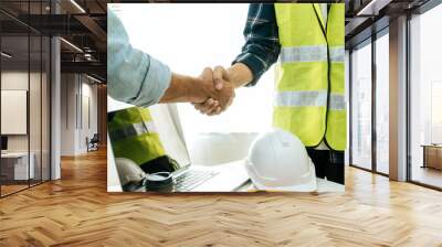 engineer, architect, construction worker team hands shaking after plan project contract on workplace desk in meeting room office at construction site, contractor, partnership, construction concept Wall mural