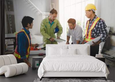 group of engineer, technician and architect planning about building plan with blueprint and construction tools on the conference table at construction site, contractor, business and industry concept Wall mural