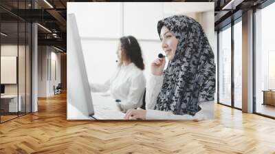 happy muslim woman female with hijab call center customer support executive with headset working in office, education online, customer support service, call center, phone operator, video call concept Wall mural