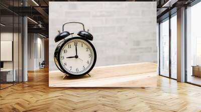 retro vintage clock on wooden table  with wall background, retro vintage concept with copy space for text. Wall mural