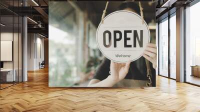 Welcome. Open. barista, waitress woman turning open sign board on glass door in modern cafe coffee shop ready to service, cafe restaurant, retail store, small business owner, food and drink concept Wall mural