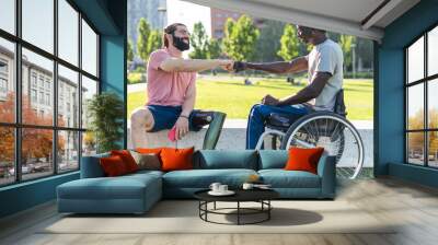 Two disabled friends give fist bump as a sign of friendship  and determination Wall mural