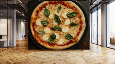 A pizza with cheese and basil on top Wall mural