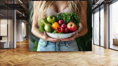 A woman holding a salad bowl with a measuring cup Wall mural