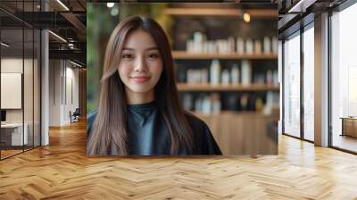 A woman with long hair is standing in front of a salon with a smile on her face Wall mural