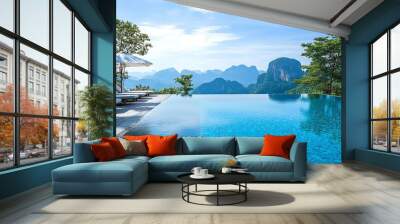 A beautiful infinity pool overlooking lush mountains in a tropical destination. Wall mural