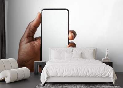 A brown hand holding mobile cell phone with blank screen for mockup design prototype isolated on a white background	 Wall mural