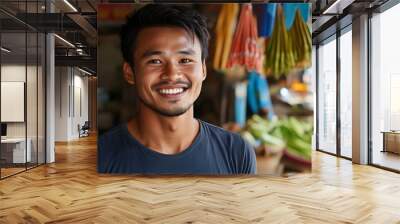 A handsome Cambodian man. Cambodia. A cheerful young man smiles in a vibrant market filled with fresh produce, showcasing a lively atmosphere. . #motw Wall mural