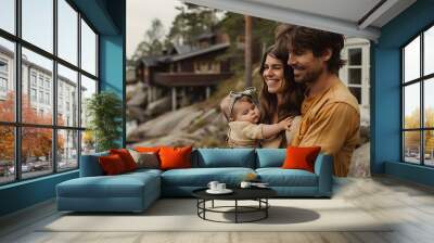 Finnish family. Finland. Families of the World. A happy family with a young child enjoying a serene moment by a lakeside cabin surrounded by nature. . #fotw Wall mural