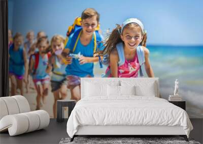 Group of children excitedly running on beach on a warm summer day Wall mural