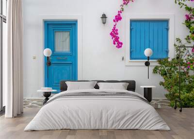 Greek house with blue doors and decorated with bougainvillea flowers on Antiparos island. Cyclades, Greece Wall mural