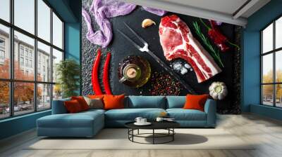 Raw meat on the kitchen table on a metallic background in a composition with cooking accessories Wall mural