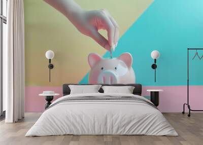 A dainty hand places a coin into a baby pink piggy bank, representing savings and financial goals against a vibrant, colorful background. Wall mural