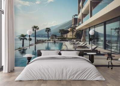 A luxurious infinity pool overlooking a tranquil coastal view with sun loungers and palm trees, offering ultimate relaxation. Wall mural