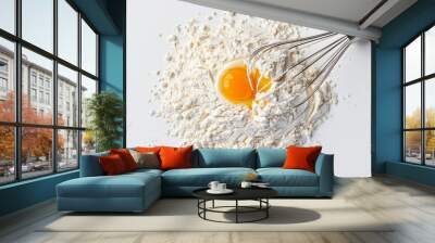 A raw egg yolk, flour, and a whisk on a white surface, depicting the messy beginnings of a baking adventure. Wall mural