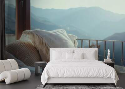 Cozy white pillows on a bed with a breathtaking view of mountain ranges through a large window. Wall mural