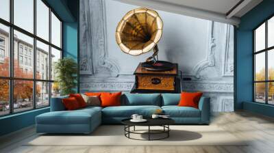 Old record player against ancient wooden wall. Antique gramophone with retro plate produces pleasant sounds or music. Stereo system. Revolution and sound technology concept Wall mural