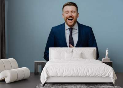 Overjoyed businessman in suit laughing out loud and having fun Wall mural