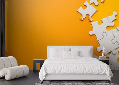 White jigsaw puzzle pieces spread out against a vibrant orange background, symbolizing problem-solving and creativity. Wall mural