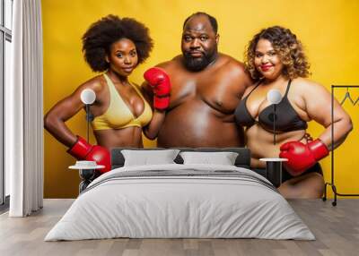 An overweight man and his girlfriends in the gym, on a yellow background Wall mural