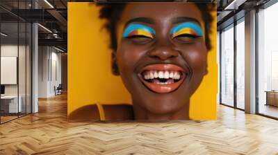 Black Colorful. Portrait of Laughing African American Woman with Colorful Makeup on Yellow Background Wall mural