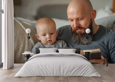 Dad Reading: Adult Male Reading Book to Baby Boy in Living Room Bonding Moment Wall mural