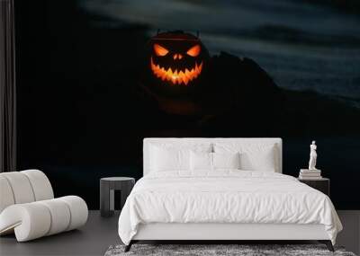 Silhouette of a jack o lantern pumpkin with the reflection on the water at night Wall mural