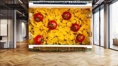 Gnocchi, raw italian pasta and cherry tomatoes in a wooden crate in a rustic composition. Wall mural