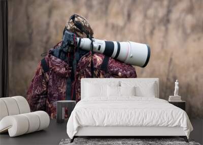 Animal Photographer. Photo Hunter. A Man In Camouflage Uniform With A Black Camera And A Large White Lens. A Man With A Camera On His Shoulder Wall mural