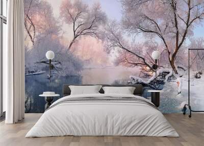 Сhristmas Lace.Winter landscape in pink tones with hoarfrost everywhere.Mostly calm winter river, surrounded by trees covered with hoarfrost and snow that falls on a beautiful pink morning light.  Wall mural