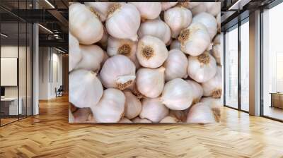 white garlic pile texture. fresh garlic on market table closeup photo. vitamin healthy food spice im Wall mural