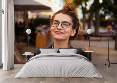 business woman in suit portrait during travel for company meeting outdoor brunette with glasses. Wall mural