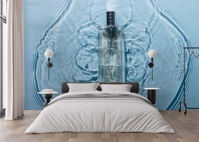 Perfume bottle on blue water wavy background. Fresh sea fragrance concept. Pure and chilly. Wall mural