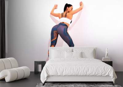 Back view of young woman in sportswear on white background with copy space. Full length portrait. Sport, fitness and people concept Wall mural