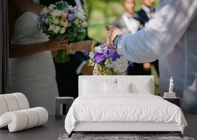 guests give presents to the newlyweds at the wedding ceremony. guest giving bouquet to bride and groom. soft focus Wall mural