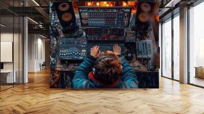 A sound engineer working on a large mixing console during a live music event at dusk, surrounded by audio equipment and dim lighting Wall mural