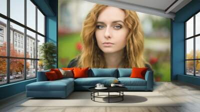 Portrait of attractive young woman with blue eyes. Wall mural