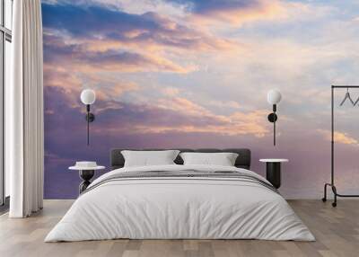 Sunset with clouds reflected in water. Wall mural