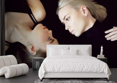 Top view of two young women on dark background. Wall mural